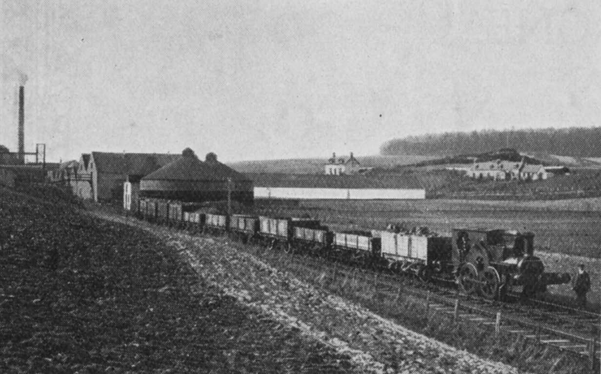 Glenlossie : Distillery locomotive and filter towers.